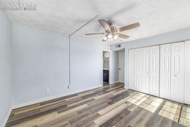 3210 Van Teylingen Dr Unit E, Colorado Springs, CO 80917 - unfurnished bedroom with wood finished floors, a textured ceiling, a closet, and ceiling fan