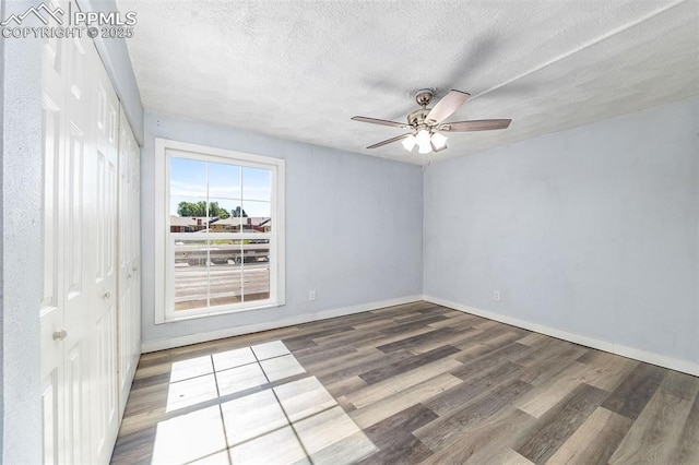 3210 Van Teylingen Dr Unit E, Colorado Springs, CO 80917 - empty room with wood finished floors, a ceiling fan, and a textured ceiling