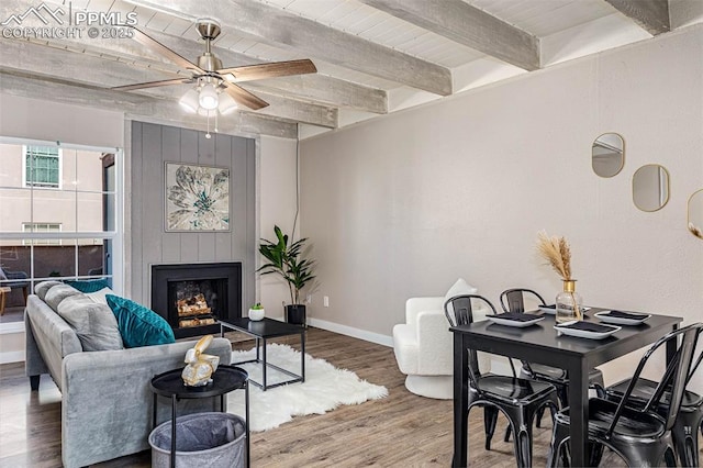 3210 Van Teylingen Dr Unit E, Colorado Springs, CO 80917 - living area featuring ceiling fan, wood finished floors, beam ceiling, and a fireplace