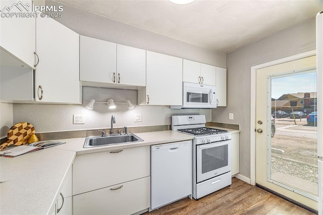 3210 Van Teylingen Dr Unit E, Colorado Springs, CO 80917 - kitchen with white appliances, light wood-style flooring, white cabinetry, and light countertops