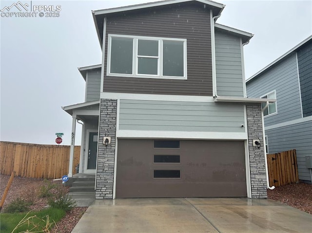 6211 Godwit Ln, Colorado Springs, CO 80925 - contemporary house featuring stone siding, driveway, and a garage