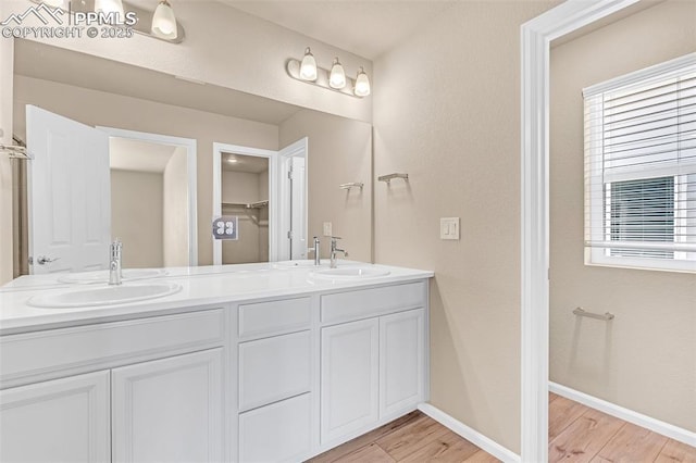 6211 Godwit Ln, Colorado Springs, CO 80925 - full bathroom featuring wood finished floors and double vanity