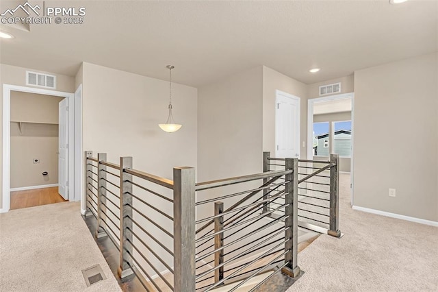 6211 Godwit Ln, Colorado Springs, CO 80925 - hallway with an upstairs landing, carpet, and recessed lighting