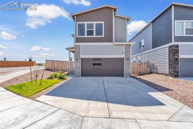 6211 Godwit Ln, Colorado Springs, CO 80925 - modern home featuring an attached garage, driveway, and stone siding