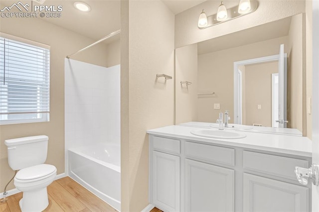 6211 Godwit Ln, Colorado Springs, CO 80925 - full bathroom with vanity, wood finished floors, and shower / washtub combination