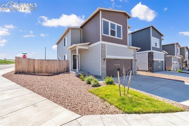 6211 Godwit Ln, Colorado Springs, CO 80925 - view of side of home with stone siding, driveway, and an attached garage