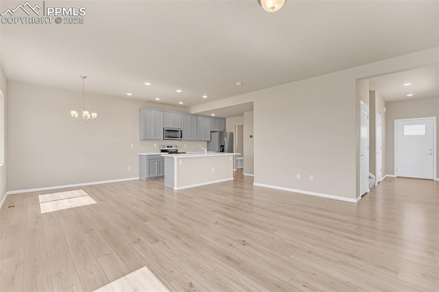 6211 Godwit Ln, Colorado Springs, CO 80925 - unfurnished living room featuring recessed lighting, a chandelier, and light wood-style flooring
