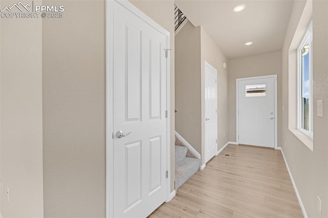 6211 Godwit Ln, Colorado Springs, CO 80925 - corridor with light wood-style floors, healthy amount of natural light, stairs, and recessed lighting