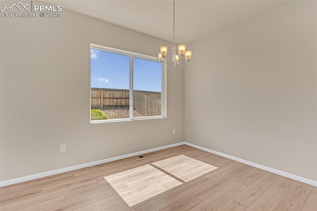 6211 Godwit Ln, Colorado Springs, CO 80925 - empty room featuring a chandelier and wood finished floors