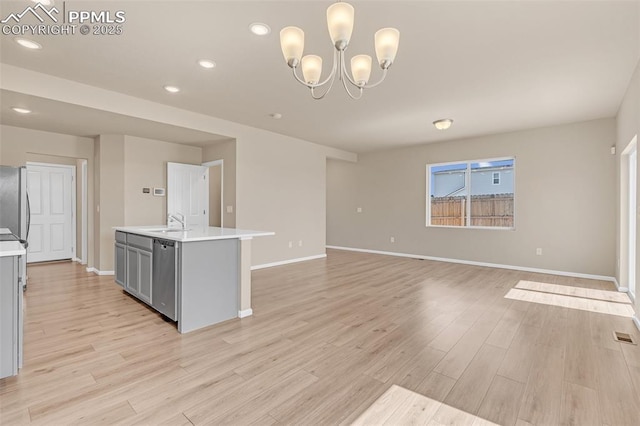 6211 Godwit Ln, Colorado Springs, CO 80925 - kitchen with gray cabinetry, light countertops, stainless steel dishwasher, recessed lighting, and light wood finished floors