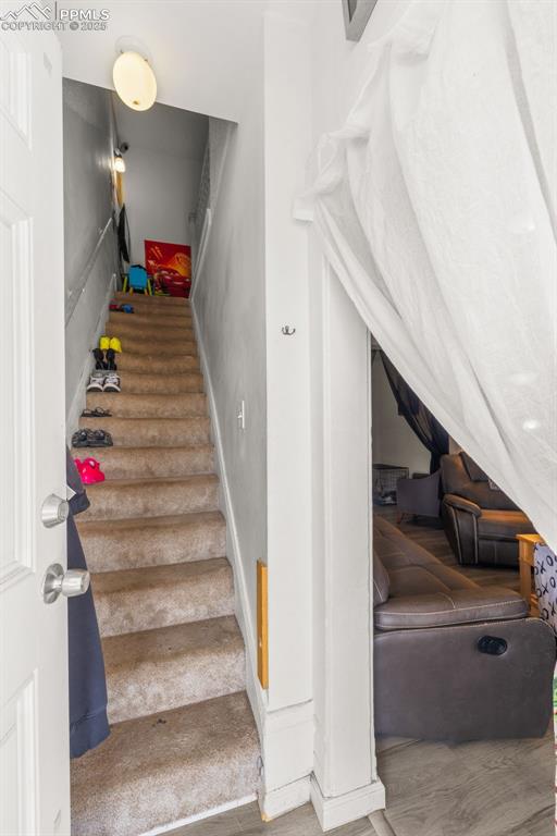 609 W 8th St Unit 611, Pueblo, CO 81003 - staircase featuring wood finished floors and baseboards