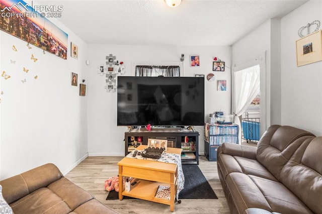 609 W 8th St Unit 611, Pueblo, CO 81003 - living room with wood finished floors and a textured ceiling