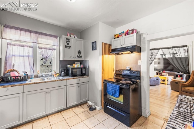 609 W 8th St Unit 611, Pueblo, CO 81003 - kitchen featuring black appliances, under cabinet range hood, gray cabinetry, and light tile patterned floors