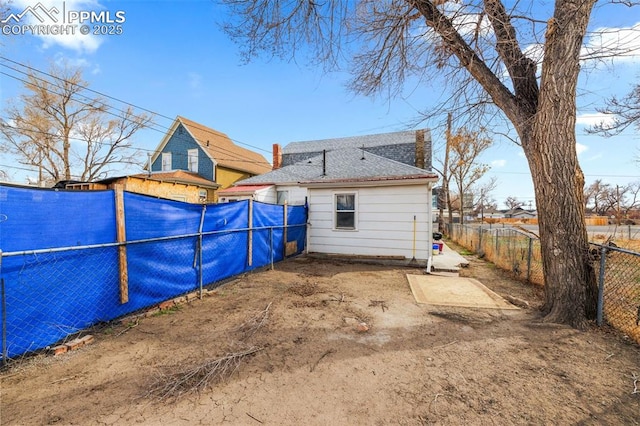 609 W 8th St Unit 611, Pueblo, CO 81003 - back of house with a fenced backyard and a shingled roof