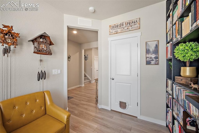 8082 Goldenray Pl, Colorado Springs, CO 80908 - sitting room featuring light wood-style flooring and stairs