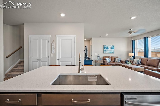 8082 Goldenray Pl, Colorado Springs, CO 80908 - kitchen with open floor plan, stainless steel dishwasher, light stone counters, a ceiling fan, and recessed lighting