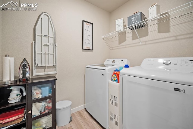 8082 Goldenray Pl, Colorado Springs, CO 80908 - laundry area featuring washing machine and clothes dryer and light wood-style floors