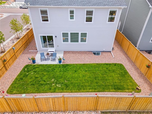 8082 Goldenray Pl, Colorado Springs, CO 80908 - back of property featuring roof with shingles, a patio area, and a fenced backyard