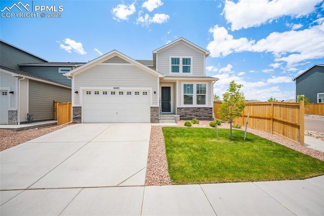 8082 Goldenray Pl, Colorado Springs, CO 80908 - craftsman house with an attached garage, stone siding, and concrete driveway