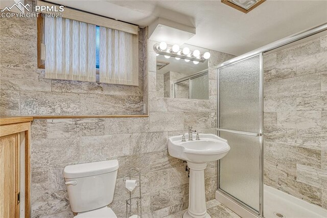 2533 Bennett Ave, Colorado Springs, CO 80909 - bathroom featuring a stall shower and tile walls