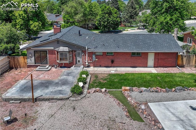 2533 Bennett Ave, Colorado Springs, CO 80909 - rear view of property with brick siding, a chimney, roof with shingles, and entry steps
