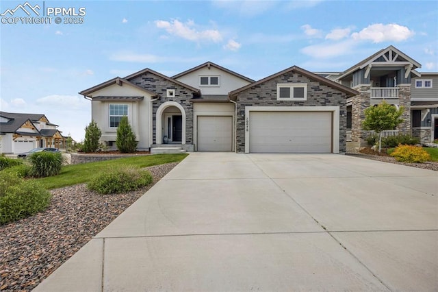 10076 Oro Belle Ct, Colorado Springs, CO 80924 - view of front facade with driveway, an attached garage, stone siding, and stucco siding