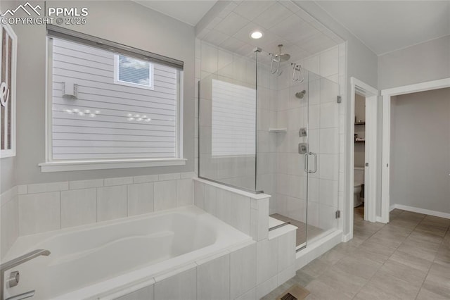 10076 Oro Belle Ct, Colorado Springs, CO 80924 - bathroom with a stall shower, a bath, and tile patterned flooring