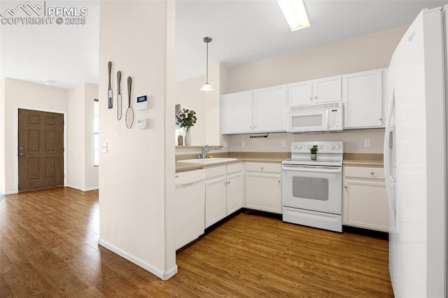 8753 Bamboo Grv, Colorado Springs, CO 80951 - kitchen with white appliances, dark wood finished floors, white cabinets, and pendant lighting