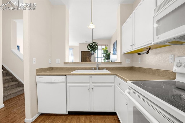 8753 Bamboo Grv, Colorado Springs, CO 80951 - kitchen with white appliances, wood finished floors, white cabinetry, and light countertops