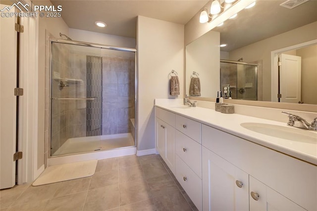 6069 Inman Vw, Colorado Springs, CO 80924 - full bathroom with double vanity, a stall shower, tile patterned floors, and recessed lighting