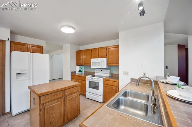 2035 Springcrest Rd, Colorado Springs, CO 80920 - kitchen featuring white appliances, tile counters, a peninsula, a kitchen island, and light tile patterned floors