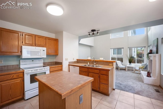 2035 Springcrest Rd, Colorado Springs, CO 80920 - kitchen featuring white appliances, tile countertops, a peninsula, open floor plan, and light colored carpet