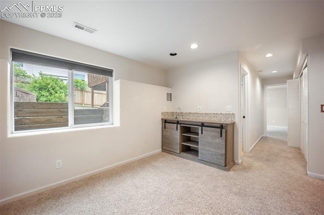 2035 Springcrest Rd, Colorado Springs, CO 80920 - unfurnished living room with light colored carpet and recessed lighting