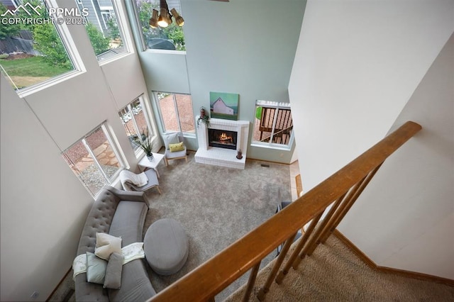 2035 Springcrest Rd, Colorado Springs, CO 80920 - carpeted living area featuring a high ceiling and a brick fireplace