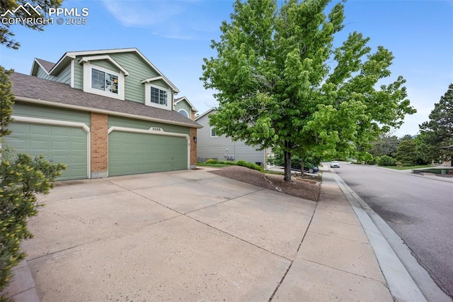 2035 Springcrest Rd, Colorado Springs, CO 80920 - view of property exterior with driveway, brick siding, a garage, and a shingled roof