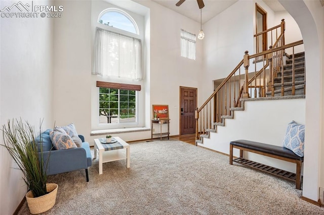 2035 Springcrest Rd, Colorado Springs, CO 80920 - entrance foyer with stairs, a high ceiling, arched walkways, carpet floors, and ceiling fan