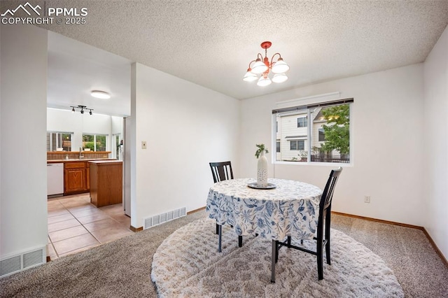 2035 Springcrest Rd, Colorado Springs, CO 80920 - dining room featuring light carpet, a chandelier, and a textured ceiling