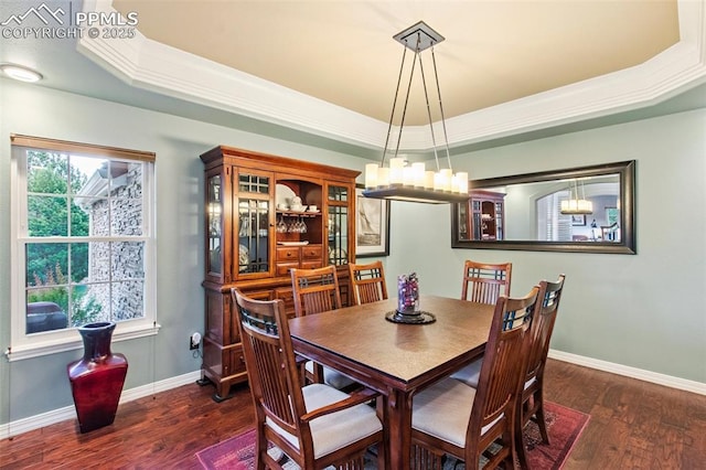 235 Haversham Dr, Colorado Springs, CO 80906 - dining space with a tray ceiling, dark wood-type flooring, a chandelier, and crown molding