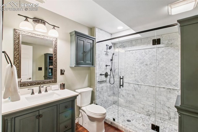 235 Haversham Dr, Colorado Springs, CO 80906 - full bathroom featuring vanity, a stall shower, wood finished floors, and recessed lighting