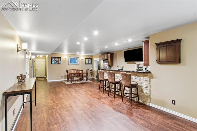 235 Haversham Dr, Colorado Springs, CO 80906 - indoor wet bar with recessed lighting, wood finished floors, and freestanding refrigerator