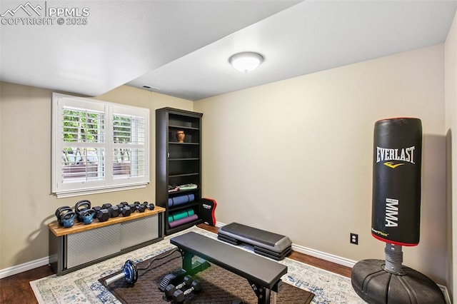 235 Haversham Dr, Colorado Springs, CO 80906 - exercise room featuring dark wood-style floors and radiator heating unit