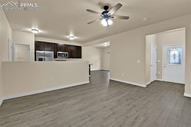 7385 Forest Meadows Ave, Colorado Springs, CO 80908 - kitchen with stainless steel appliances, a ceiling fan, dark brown cabinets, wood finished floors, and open floor plan