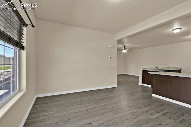 7385 Forest Meadows Ave, Colorado Springs, CO 80908 - unfurnished living room featuring ceiling fan and dark wood-style flooring