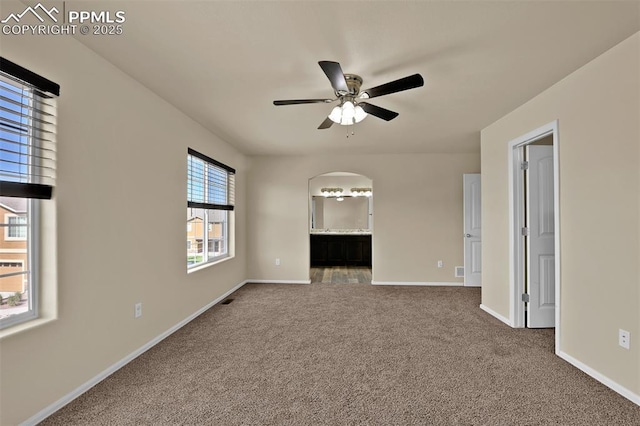 7385 Forest Meadows Ave, Colorado Springs, CO 80908 - carpeted empty room with ceiling fan and arched walkways