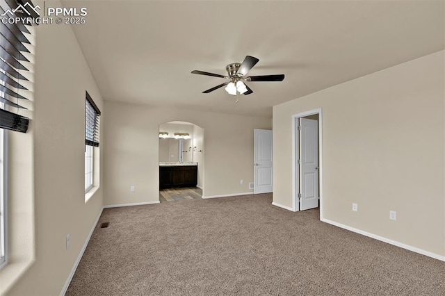 7385 Forest Meadows Ave, Colorado Springs, CO 80908 - carpeted spare room featuring arched walkways and ceiling fan