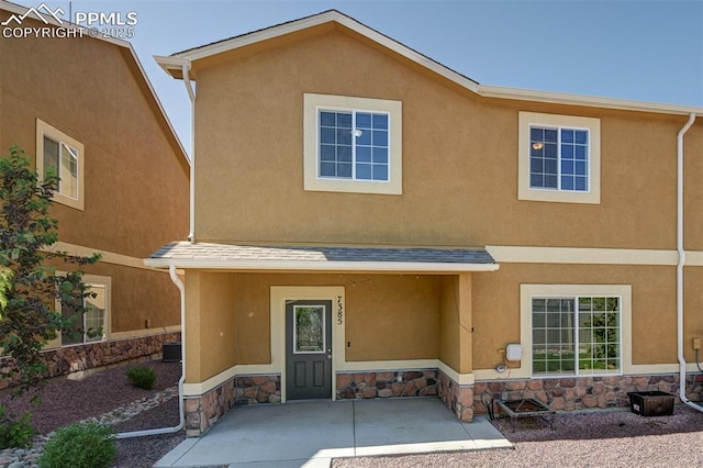 7385 Forest Meadows Ave, Colorado Springs, CO 80908 - view of front facade featuring stone siding and stucco siding