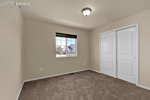 7385 Forest Meadows Ave, Colorado Springs, CO 80908 - unfurnished bedroom featuring dark carpet and a closet