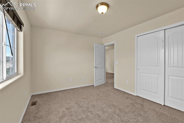 7385 Forest Meadows Ave, Colorado Springs, CO 80908 - unfurnished bedroom featuring carpet floors, multiple windows, and a closet