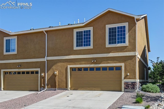 7385 Forest Meadows Ave, Colorado Springs, CO 80908 - view of property with an attached garage and stucco siding