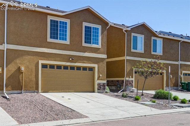 7385 Forest Meadows Ave, Colorado Springs, CO 80908 - multi unit property with stucco siding, a garage, concrete driveway, and stone siding